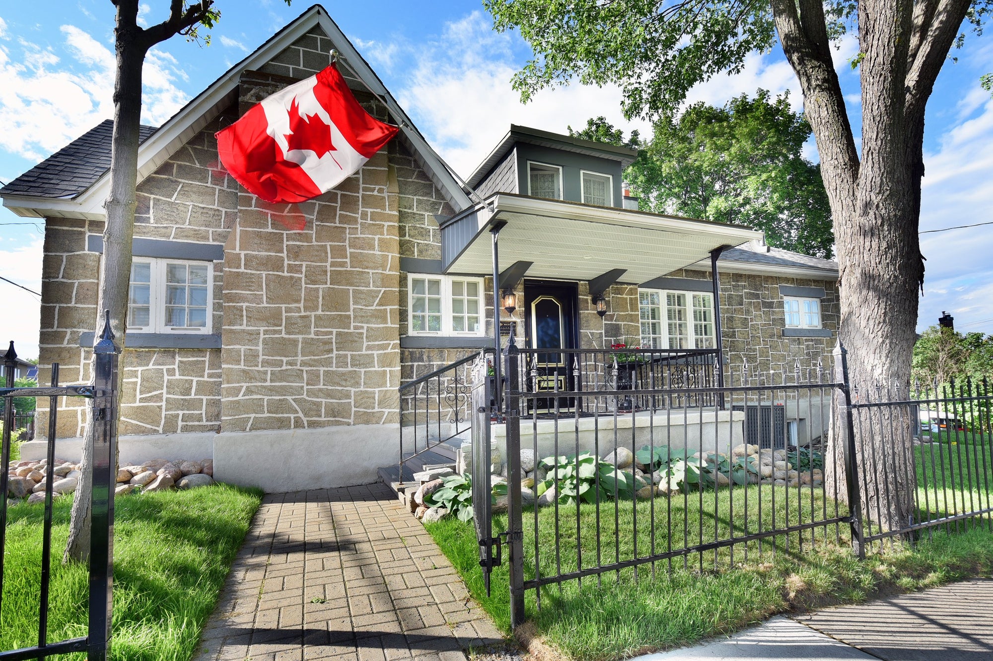 Canadian flag waving in the wind above the entrance of Beckwith Galleries' Ottawa location.