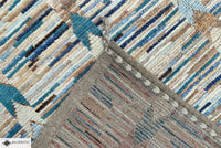 Close-up of a textured rug with geometric pattern in earthy tones